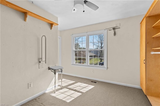 unfurnished room featuring a ceiling fan, baseboards, visible vents, and carpet flooring