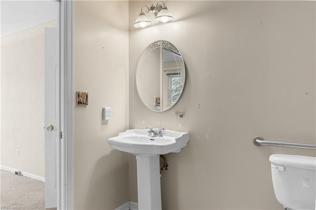 bathroom with baseboards and toilet