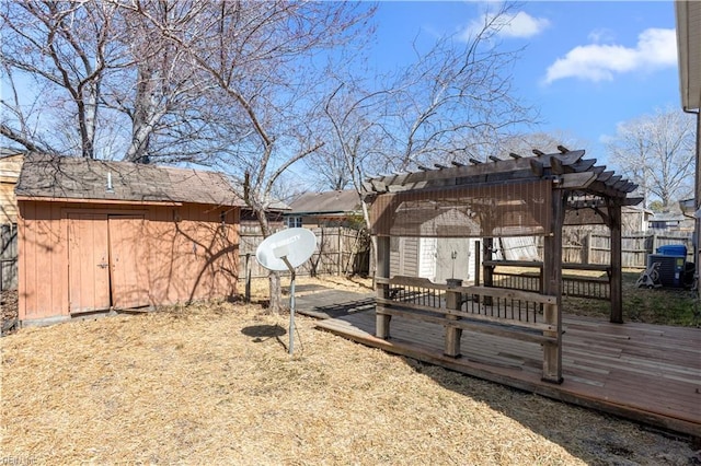 view of yard featuring a shed, an outbuilding, a pergola, and a fenced backyard