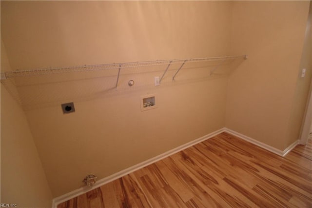 laundry area with gas dryer hookup, laundry area, baseboards, light wood-type flooring, and electric dryer hookup