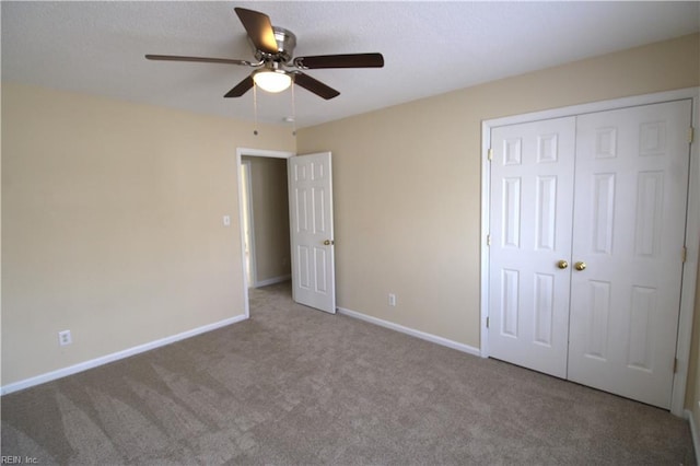 unfurnished bedroom with baseboards, a ceiling fan, a textured ceiling, carpet floors, and a closet