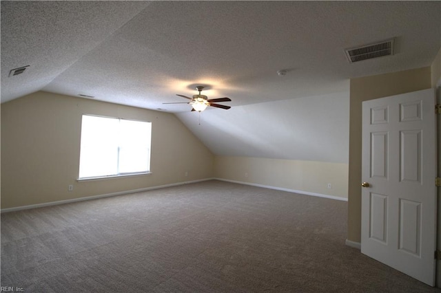 bonus room featuring carpet floors, visible vents, and a textured ceiling