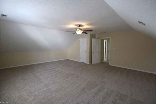 additional living space with a textured ceiling, visible vents, and baseboards