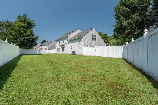 view of yard featuring a fenced backyard and central AC