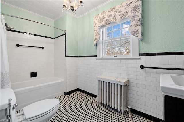 bathroom with toilet, tile walls, crown molding, and radiator heating unit