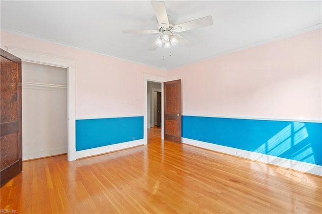 unfurnished room with baseboards, crown molding, a ceiling fan, and wood finished floors