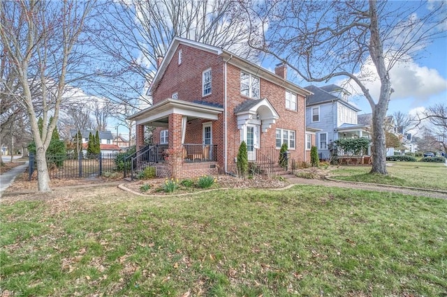 view of front of house with brick siding, covered porch, a chimney, and a front yard