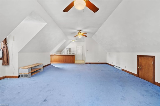 bonus room with vaulted ceiling, a baseboard heating unit, baseboards, and carpet floors