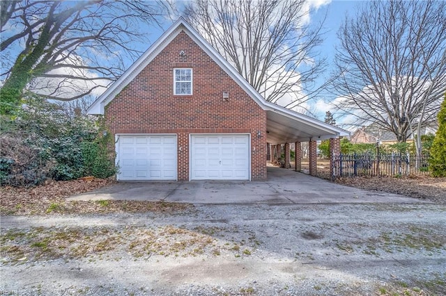 view of side of home with brick siding and fence