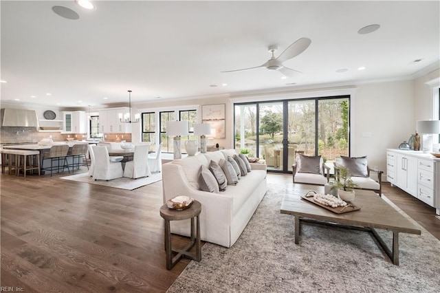 living room featuring dark wood-style floors, crown molding, and recessed lighting