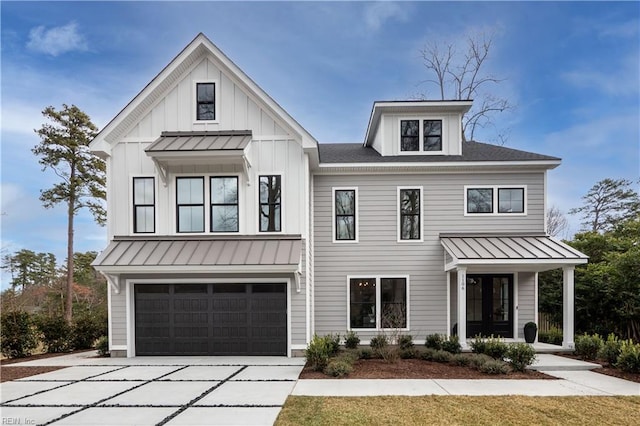 modern inspired farmhouse with concrete driveway, roof with shingles, an attached garage, a standing seam roof, and board and batten siding