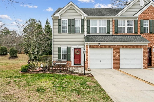 view of front facade with a front yard, brick siding, a garage, and driveway