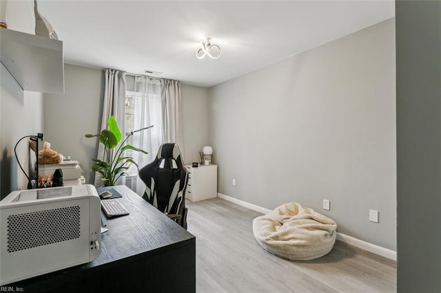 office with light wood-type flooring and baseboards