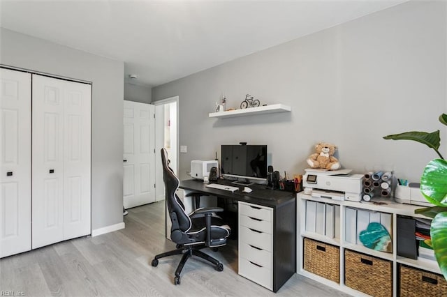 office with light wood-style floors and baseboards