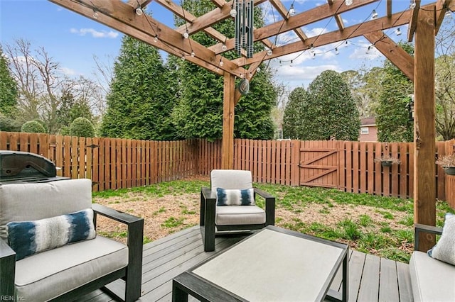 deck with a pergola and a fenced backyard