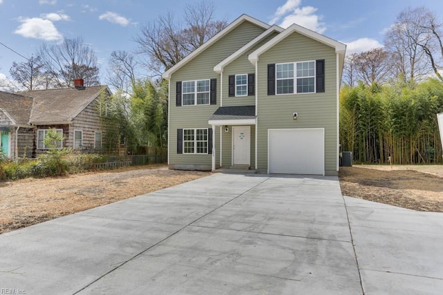 view of front facade featuring concrete driveway, central AC, and an attached garage