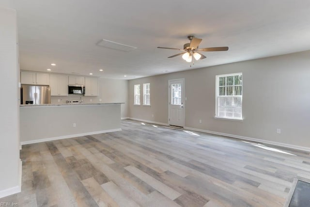 unfurnished living room with a ceiling fan, light wood-type flooring, baseboards, and recessed lighting