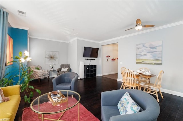 living room with baseboards, visible vents, ceiling fan, wood finished floors, and crown molding