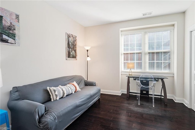 office area with visible vents, baseboards, and wood finished floors