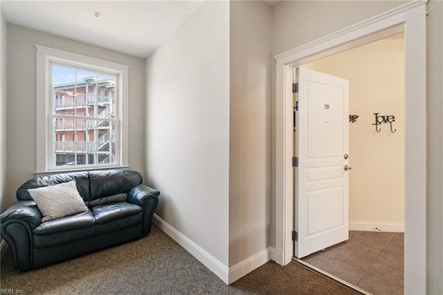 sitting room featuring carpet floors, tile patterned flooring, and baseboards