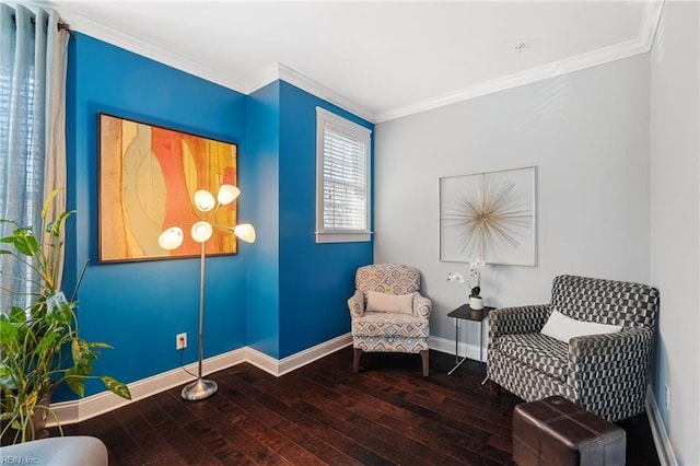 sitting room with crown molding, baseboards, and hardwood / wood-style flooring