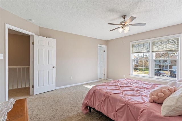 bedroom featuring carpet flooring, ceiling fan, a textured ceiling, and baseboards