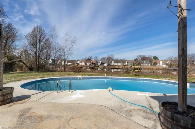 outdoor pool with a patio area and a residential view