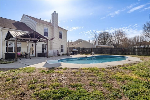 view of swimming pool with a patio area, a fenced in pool, and a fenced backyard