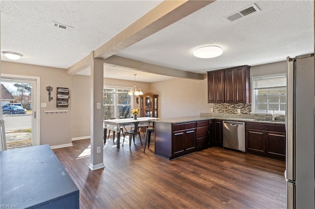 kitchen featuring a peninsula, dark brown cabinets, visible vents, and appliances with stainless steel finishes