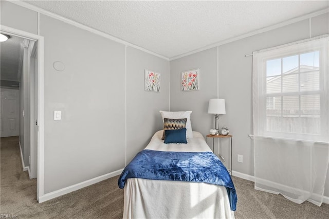 carpeted bedroom featuring a textured ceiling, baseboards, and crown molding