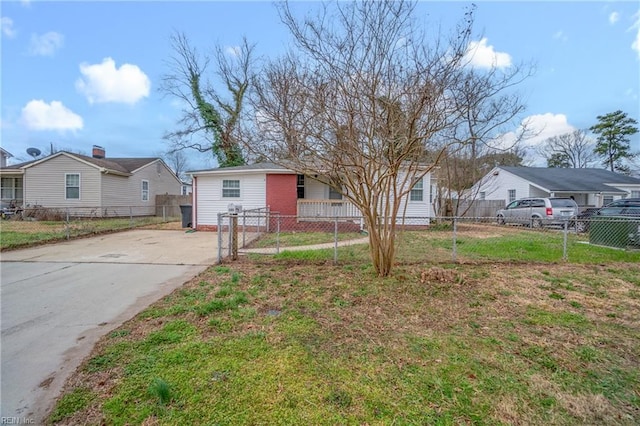 view of front of property with a fenced front yard, a residential view, driveway, and a front yard