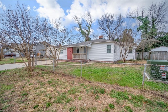 ranch-style house featuring fence, a chimney, and a front lawn