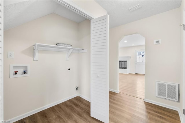 laundry area with washer hookup, visible vents, hookup for an electric dryer, wood finished floors, and laundry area