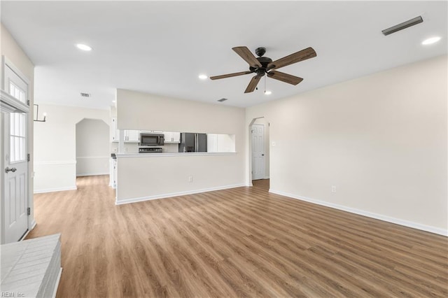 unfurnished living room with a ceiling fan, recessed lighting, visible vents, and light wood-style floors