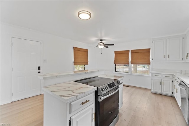 kitchen featuring light stone counters, a center island, stainless steel appliances, white cabinetry, and light wood-type flooring