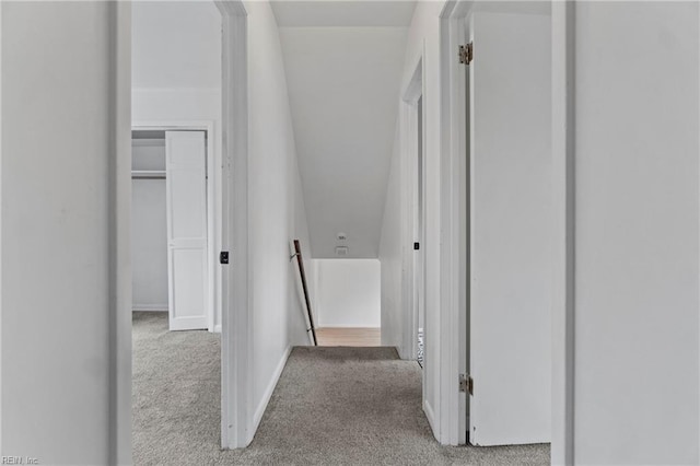 corridor with carpet flooring and baseboards