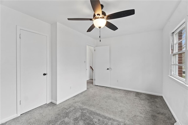 interior space with a ceiling fan and baseboards