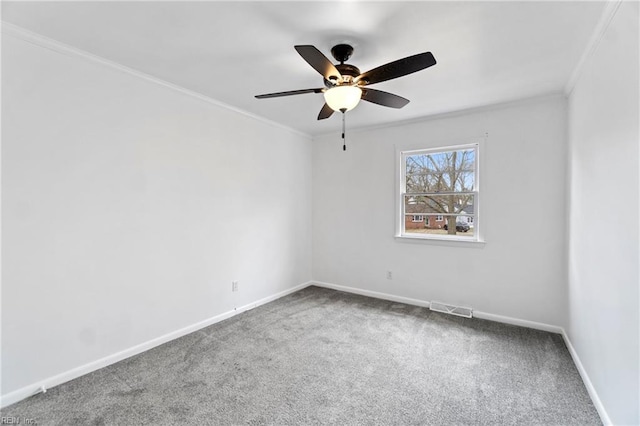 unfurnished room featuring baseboards, visible vents, a ceiling fan, ornamental molding, and carpet flooring