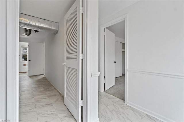 hall featuring marble finish floor