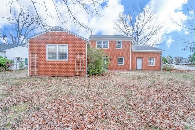 back of property with brick siding and fence