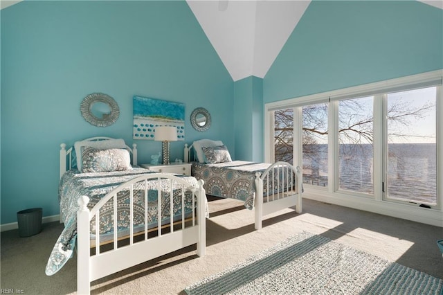 bedroom with baseboards, high vaulted ceiling, and carpet flooring