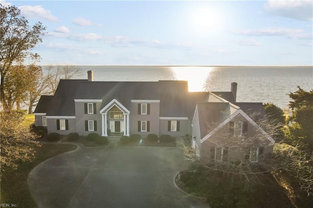 view of front of home featuring a water view and stucco siding