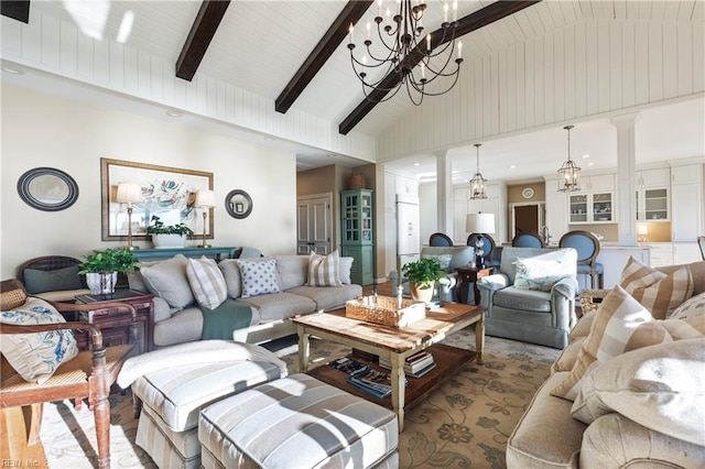 living room featuring high vaulted ceiling, a notable chandelier, beamed ceiling, and ornate columns