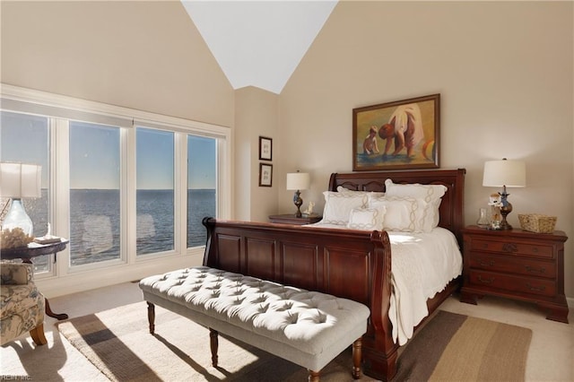 bedroom featuring high vaulted ceiling and light colored carpet