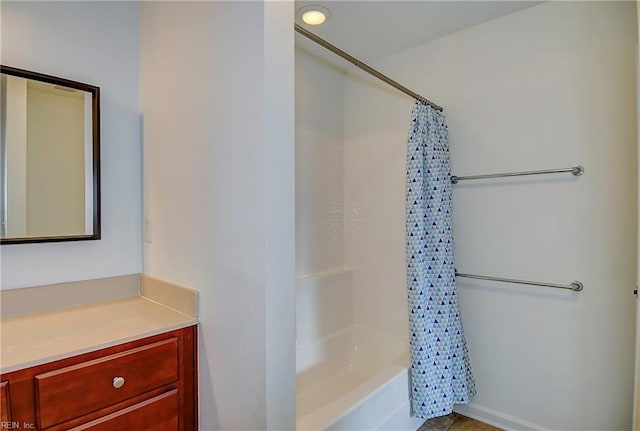 bathroom featuring vanity and shower / bathtub combination with curtain