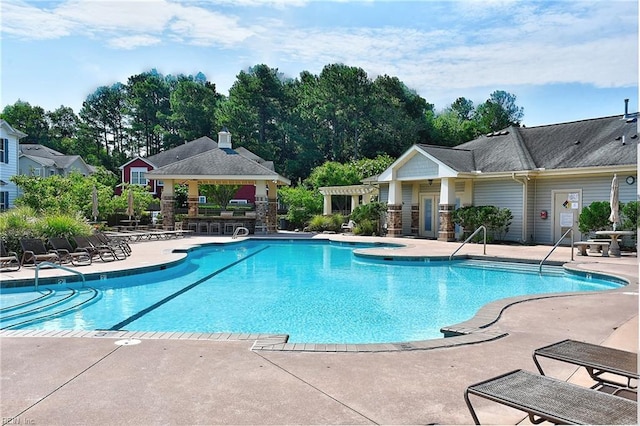 community pool with a patio and a gazebo