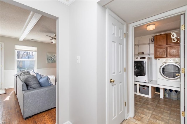 washroom with cabinet space, ceiling fan, a textured ceiling, and washing machine and clothes dryer