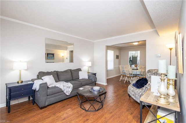 living room with baseboards, ornamental molding, and wood finished floors