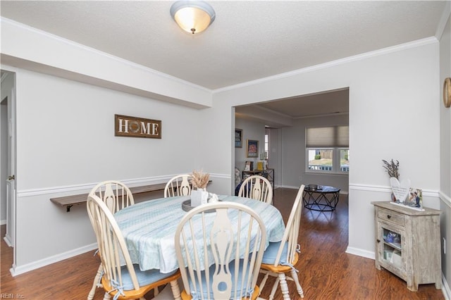 dining area featuring crown molding, a textured ceiling, and wood finished floors