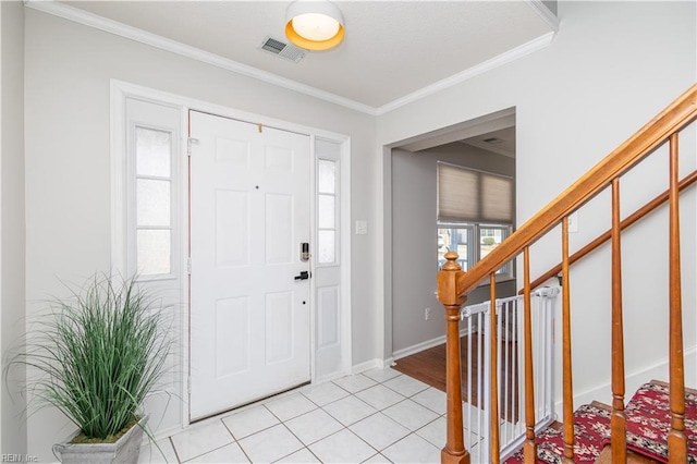 entryway with ornamental molding, visible vents, stairway, and light tile patterned floors